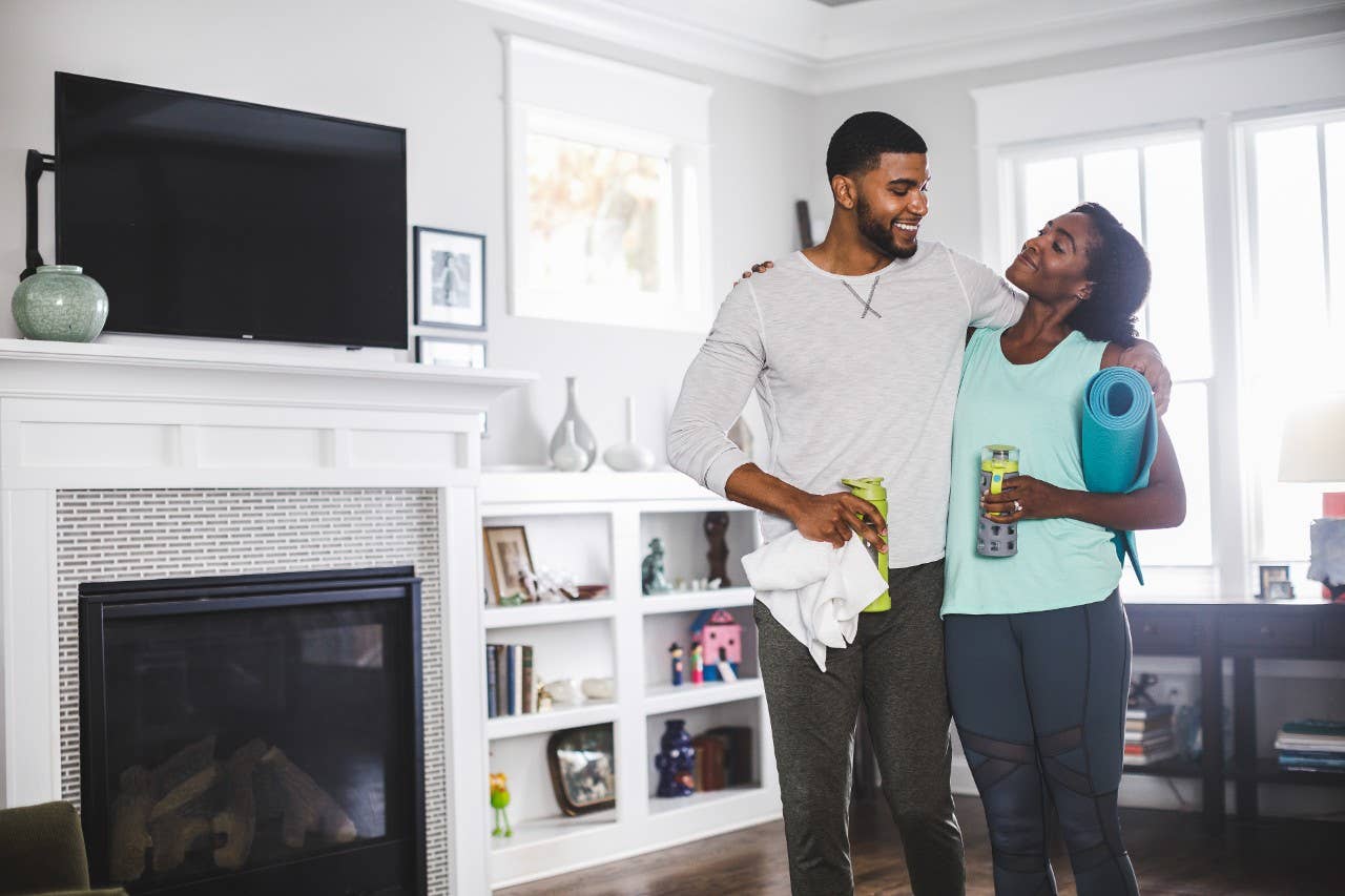 Couple embrace in living room.